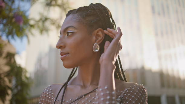 istock African woman touching braids looking camera posing sunbeams square portrait 2079060061
