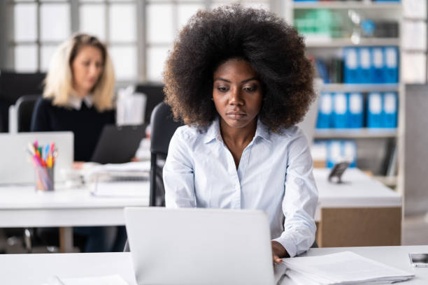 istock Serious looking and concentrated afro female worker at the office, looking hard working and stressed 2079061756