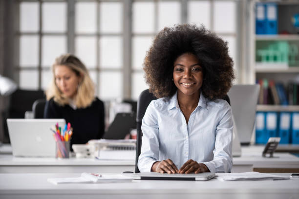 istock Smiling and joyful afro female worker at the office, looking inspired and successful 2079061764