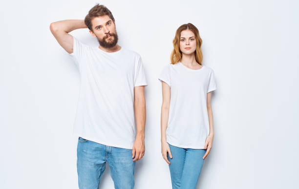 istock A guy and a beautiful woman in the same clothes on a light background are gesticulating with their hands 2079080926