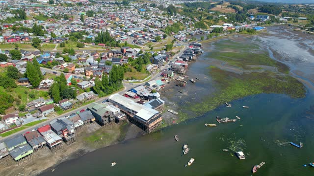 Aerial Drone Flyover Castro Waterway With Traditional Boats And Houses, Chile Chiloe, 4K