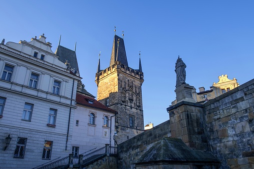 Prague, Czech Republic, January 28, 2024: Low angle view of the Lesser Town Bridge Tower (Czech: Malostranská mostecká v) on a sunny day. The tower serves as the entrance to Malá Strana from the Charles Bridge.