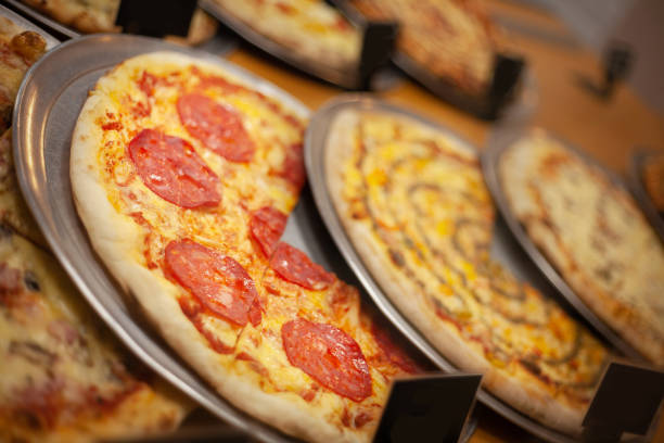 istock Different types of delicious pizza on the table with tomatoes and cheese 2079104596