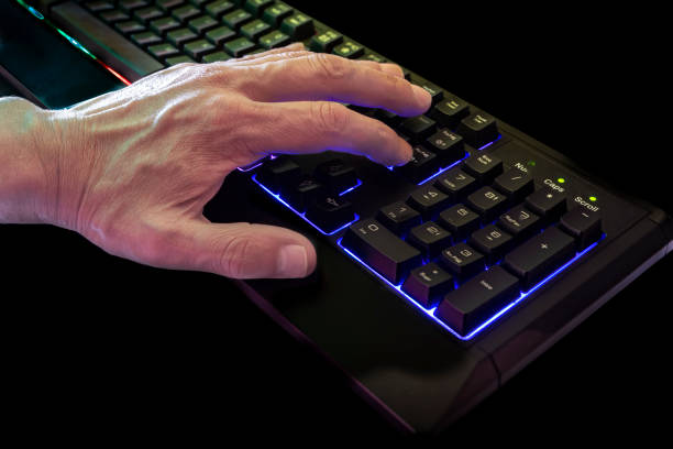 istock Hand Man Typing on Illuminated Keyboard of a Computer 2079114903