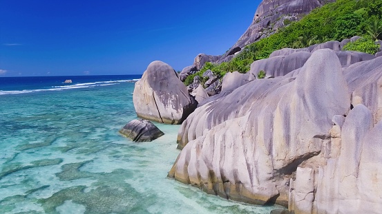 Anse Source D'Argent Beach in La Digue, Seychelles. Aerial view of tropical coastline on a sunny day.