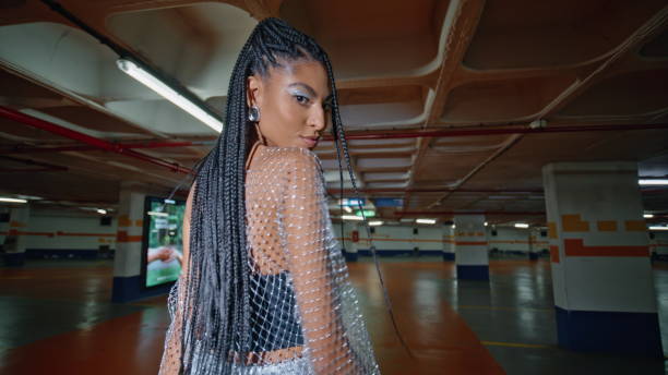istock Modish woman posing underground parking back view. Brunette dancing shoulders 2079138558