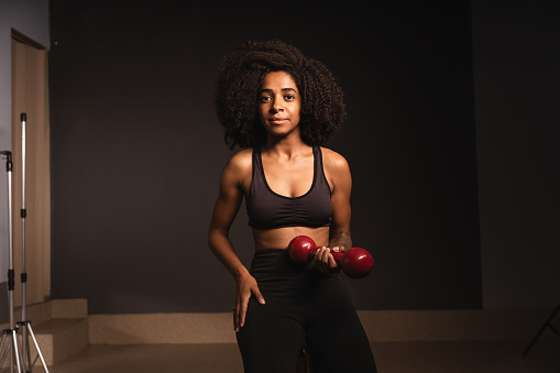 Portrait of a sportswoman holding a gym weight