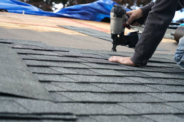 istock handyman using nail gun to install shingle to repair roof 2079173038