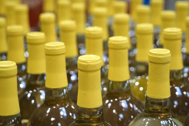 istock close up on yellow wine bottles in rows 2079218886