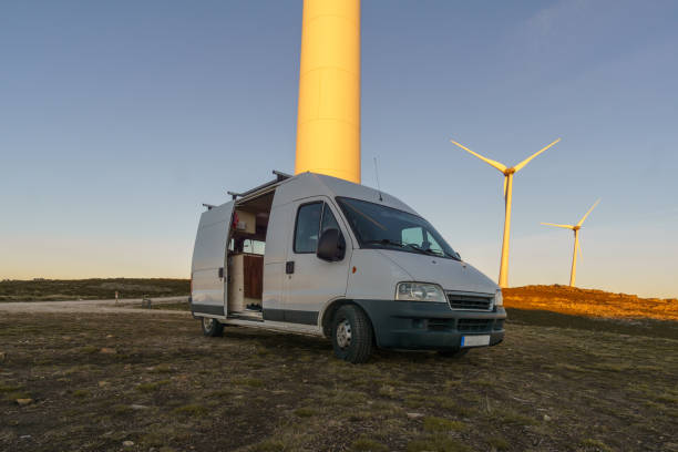 istock Wind turbines at Serra da Arada over mountain landscape at evening sunset with camper van in foreground, Sao Pedro do Sul, Portugal 2079219930
