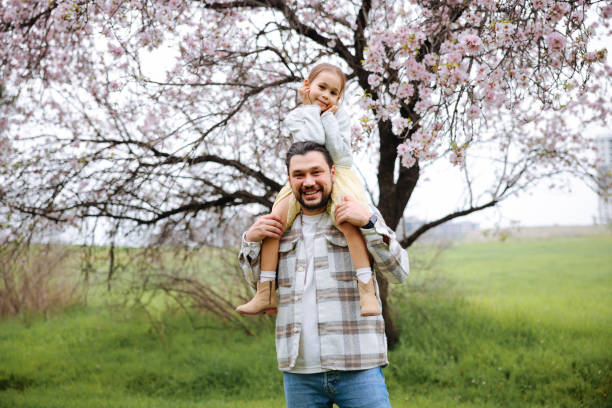 istock Young father carrying daughter on shoulders in nature 2079225638
