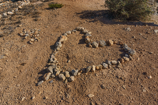 A heart shape made out of stones at Praia do Barranco beach, Sagres, Algarve, Portugal