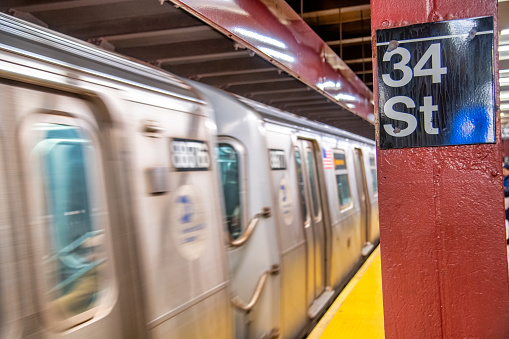 New York City - December 1, 2018: Train speeds up in the city station