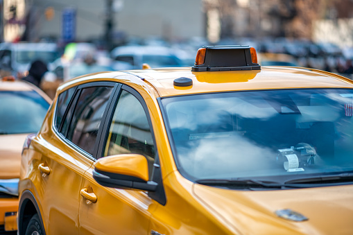 Manhattan, New York, USA - August 16, 2014.\nBusy traffic pulsing through the Times Square in New York City. Road full of cars, yellow cabs and sounds. Crossing the street. Every day life.