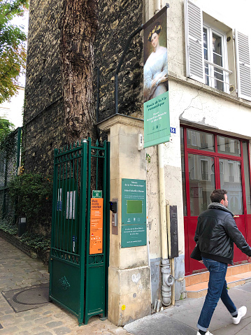 Paris, France: Man walks past the entrance of La Musée de la Vie Romantique in the Pigalle district of the 9th arrondissement; the literary museum focuses on George Sand and other authors of the Romantic Era.