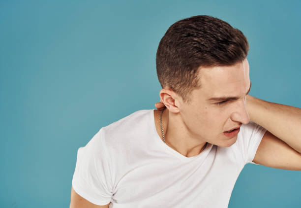 istock Cute man holds his hand behind his head displeased blue background 2079259255