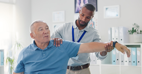 Old man, physiotherapist and arm stretching for training mobility in retirement or rehabilitation, wellness or injury. Elderly person, muscle support and performance help, recovery or consultation