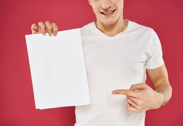 istock Guy advertises flyer on red background and mockup Copy Space 2079264021