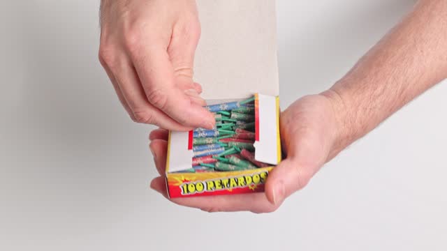 A man opens a box of firecrackers