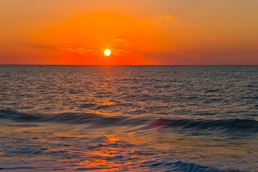 Beautiful orange sunset at Fort Myers Beach, Gulf of Mexica, Florida, USA.