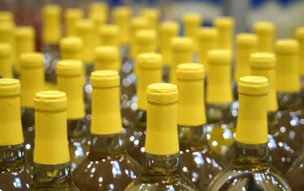 istock close up on yellow wine bottles in rows 2079327209