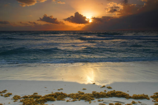 sunrise with light from behind the cloud and reflection in the ocean