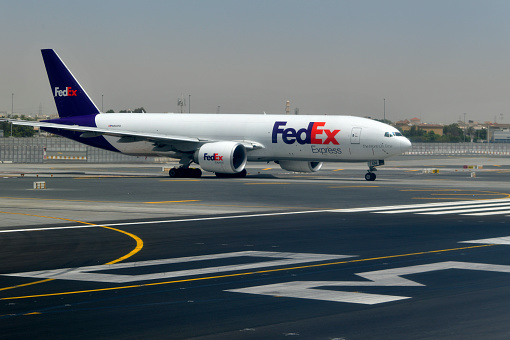 Al Garhoud district, Dubai: FedEx / Federal Express Boeing 777-FS2 (N856FD, MSN 37727), on a taxi way about to enter runway 30L. FedEx keeps a cargo logistics base at Dubai International Airport.
