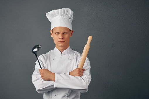 man in chef uniform kitchen appliances professional restaurant. High quality photo