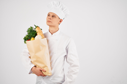 male chef with a package of groceries restaurant cooking professional. High quality photo
