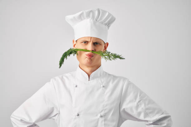 istock chef with kitchen utensils greens near face restaurant 2079358266