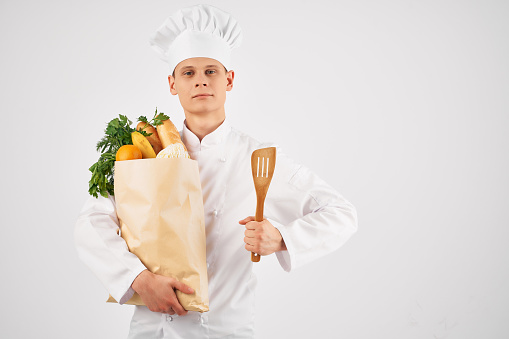 chef with a package of fresh food delivery kitchen work Professional. High quality photo