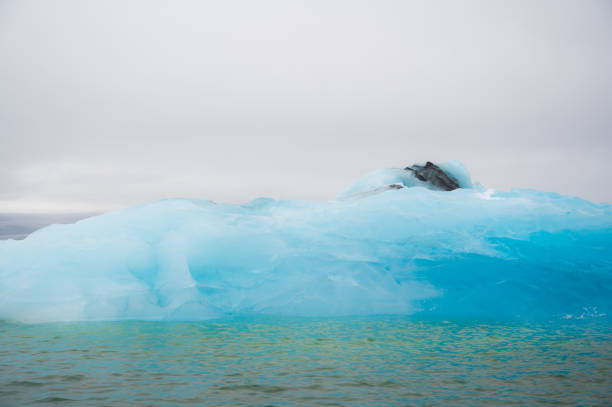 closeup texture of bright blue iceberg. Enviromental issues, global warming concept. High quality photo