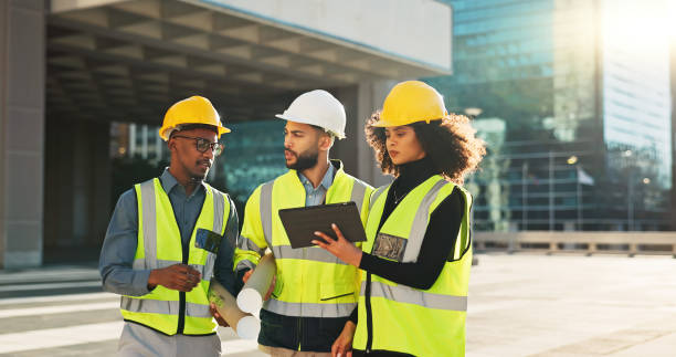 istock People, architect and team walking with tablet in planning for construction, building or project in city. Group of employees, contractor or engineer in teamwork with technology for architecture plan 2079407680