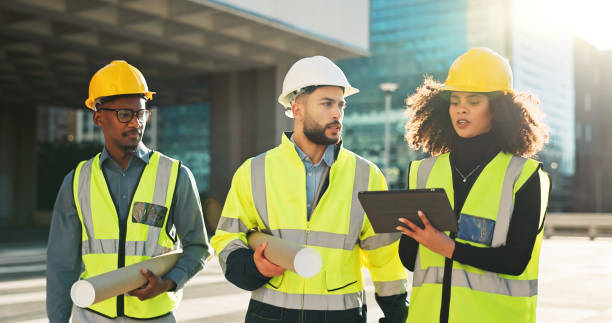 istock People, architect and tablet in city planning for meeting, construction or building project on site. Group of employees, contractor or engineer in teamwork on technology for architecture plan or idea 2079407683