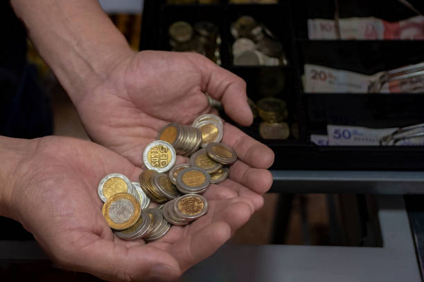 istock Man's hands with Colombian coins 2079429072
