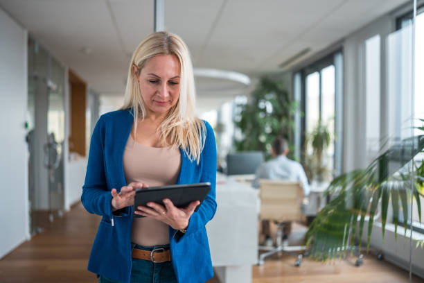 istock Happy Mature Caucasian Female Scrolling on Digital Tablet 2079454893