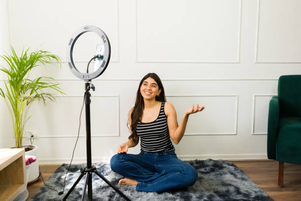 istock Young woman vlogging with ring light at home 2079469102