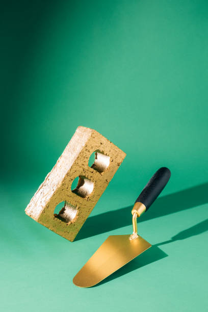 Brick shaped ingot and masonry trowel in equilibrium
