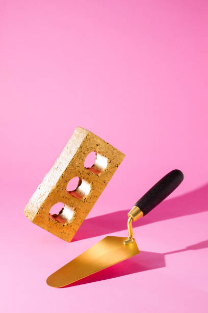 Brick shaped ingot and masonry trowel in equilibrium