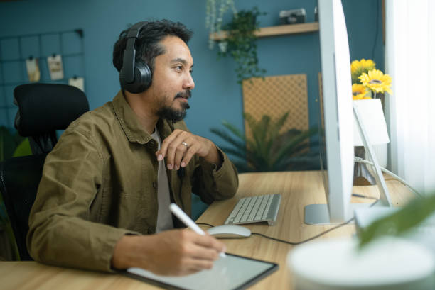 istock Mature businessman wearing wireless headphones making video calls while working on computer 2079518336