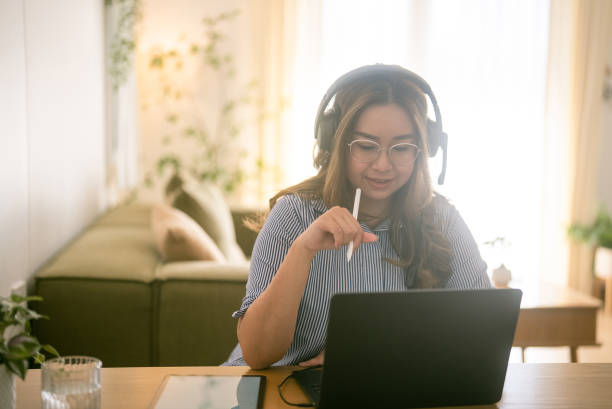 istock Happy freelancer sitting and reading a project on computer while working from home on holiday. 2079525213