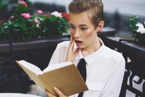 istock student with a book in his hands reading walk in the fresh air education 2079535089