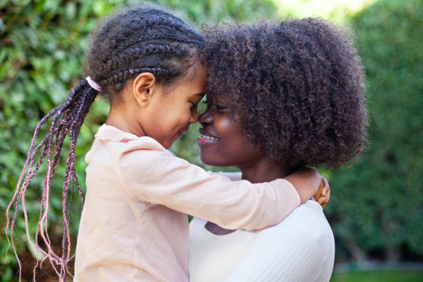 istock Spring portrait African mother embracing her child in backyard 2079561280