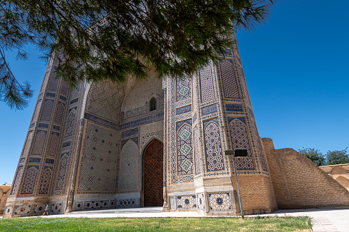 JUNE 20, 2023, SAMARKAND, UZBEKISTAN: Beautiful walls and dome of Bibi-Khanym Mosque in Samarkand, Uzbekistan. Blue sky with copy space for text