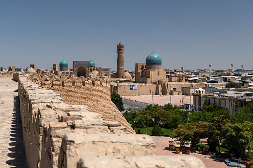 JUNE 27, 2023, BUKHARA, UZBEKISTAN: View over the Poi Kalon Mosque and Minaret from the Ark fortress, in Bukhara, Uzbekistan. Blue sky with copy space for text