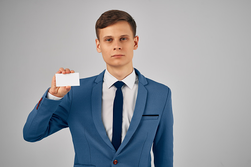 a man in a suit with a business card in his hands an identity card Copy Space professional. High quality photo