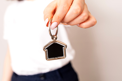 Close-up of a woman's hands holding the keys to a new house,