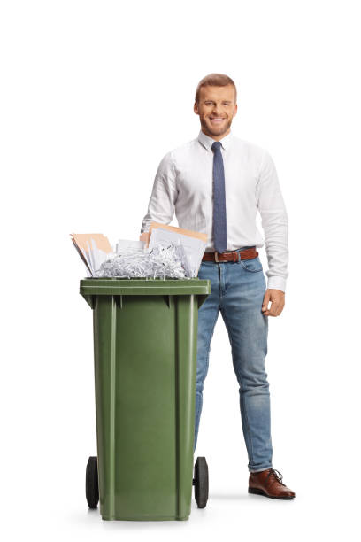 istock Office worker standing behind a bin with paper waste 2079613935