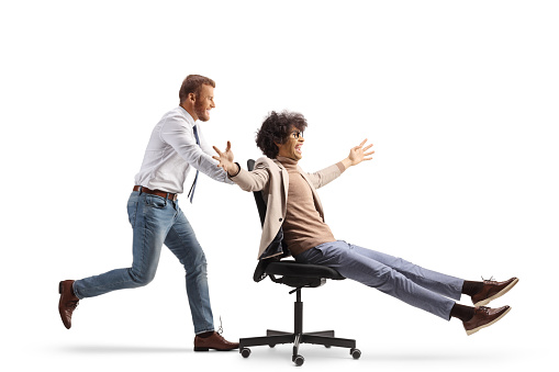 Office worker running and pushing a man on a desk chair isolated on white background