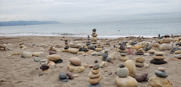 Tourists are walking on Moeraki Boulders beach, Hampden, Otago, South Island, New Zealand.